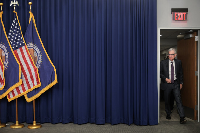 Jerome Powell entering a press conference.