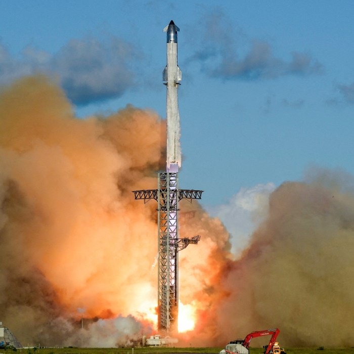 A SpaceX Super Heavy booster carrying the Starship spacecraft lifting off.
