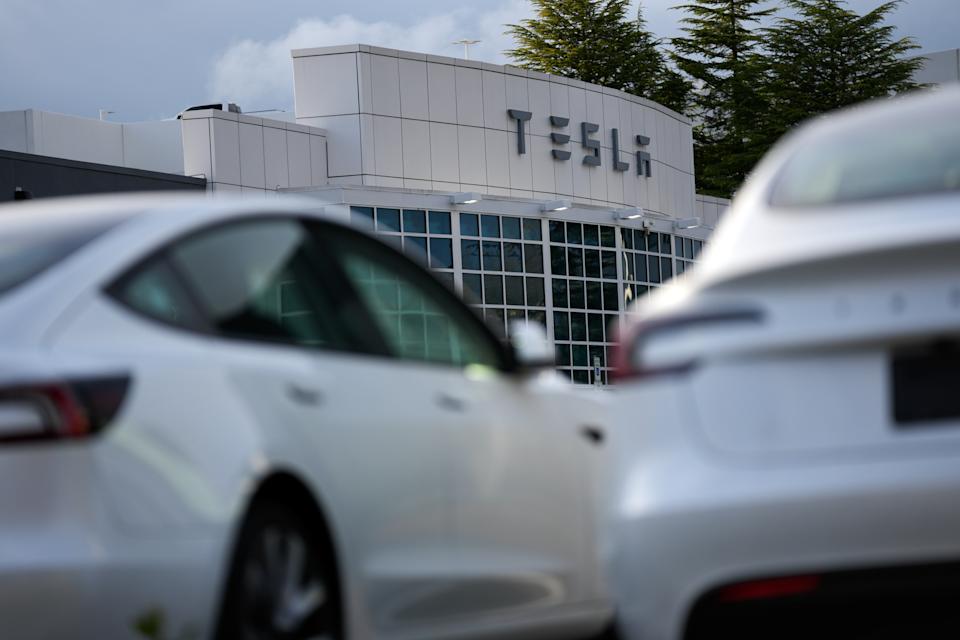 Tesla vehicles are seen at a Tesla facility Wednesday, April 15, 2026, in Portland, Ore. (AP Photo/Jenny Kane)