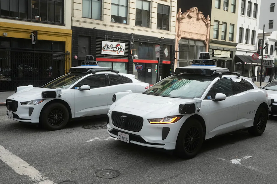 Waymo vehicles wait at an intersection in San Francisco, Wednesday, Oct. 22, 2025. (AP Photo/Jeff Chiu)