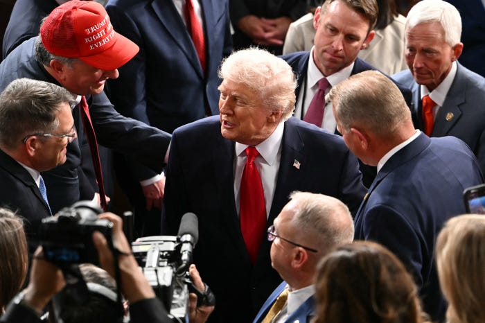 US President Donald Trump shakes hands with members of Congress as he departs following his State of the Union address in the House Chamber of the US Capitol in Washington, DC, on February 24, 2026.