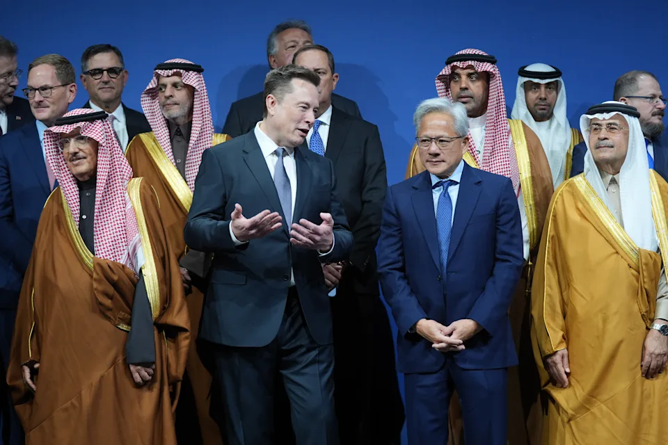 Elon Musk speaks with Nvidia CEO Jensen Huang, as they attend the Saudi Investment Forum at the Kennedy Center, Wednesday, Nov. 19, 2025, in Washington. (AP Photo/Evan Vucci)