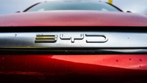 Close-up of BYD (BYDDY) logo on red car, symbolizing BYDDY stock