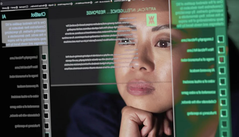 A person staring at a screen, looking at data.