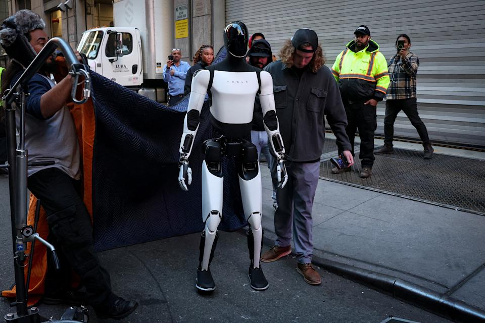 A Tesla Optimus robot walks during an appearance outside the Nasdaq Market site in New York City, U.S., October 27, 2025.  REUTERS/Brendan McDermid