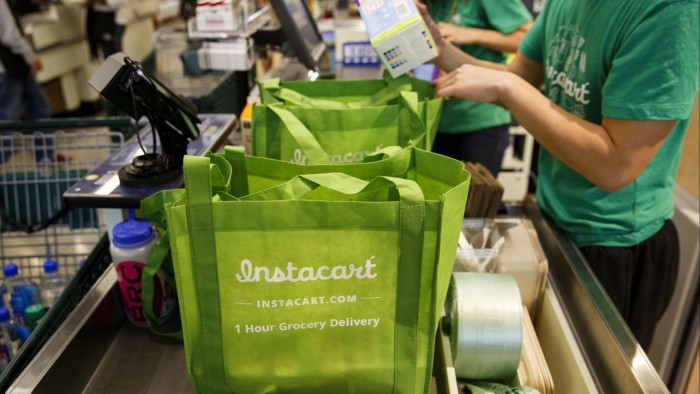Instacart employees fill orders for a Whole Foods market in Los Angeles 