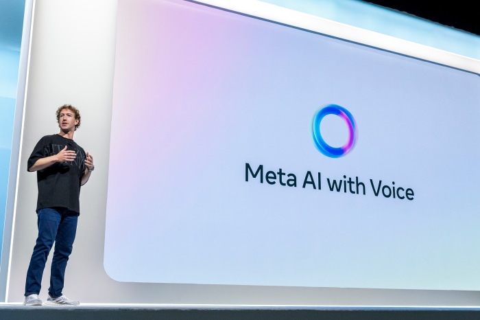 Mark Zuckerberg presenting "Meta AI with Voice" on a large screen at the Meta Connect event in 2024.