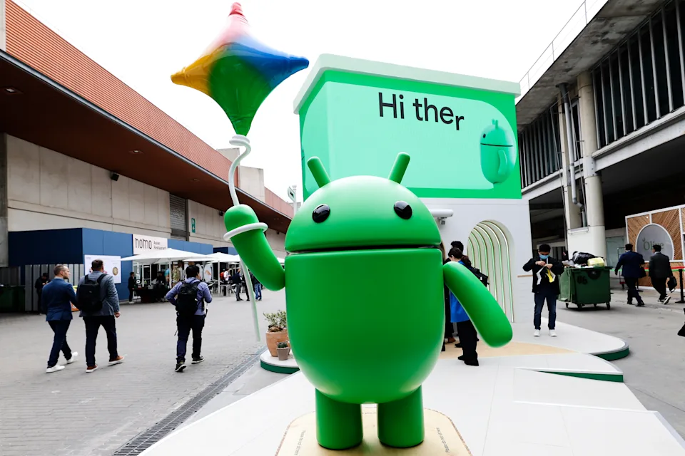 A figure of the Android Bot, the mascot of Google's operating system, an OS for mobile devices and tablets and the world's most widely used operating system, holds a balloon in the shape of Gemini AI with the Google colors during the Mobile World Congress 2025 in Barcelona, Spain, on March 5, 2025. (Photo by Joan Cros/NurPhoto via Getty Images)