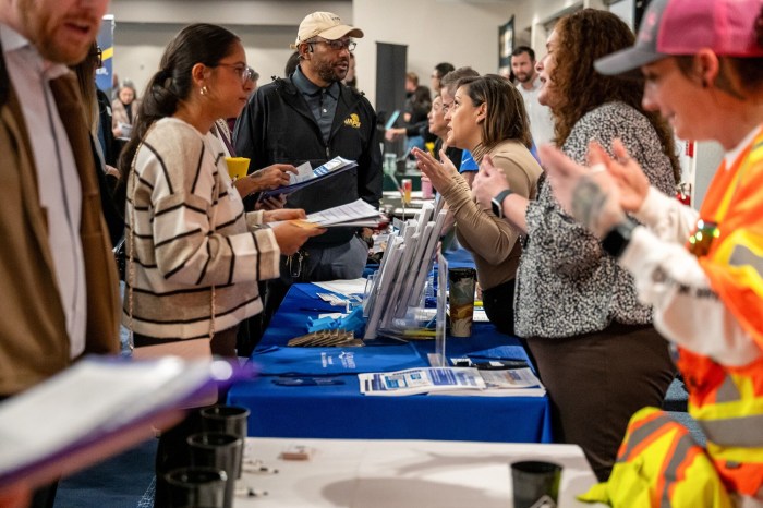 Job seekers speaking with recruiters at a career fair in Sacramento, Calif.