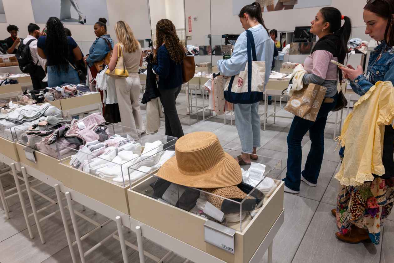 People shop at a store in Manhattan. Trade wars are raising prices on some goods such as clothes, but inflation more broadly hasn’t increased much.